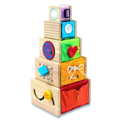 Stack of colorful wooden blocks with various shapes and textures on a white background