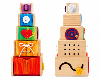 A set of colorful wooden toy blocks and boxes with various sensory and motor activity inserts, shown on a clean white background.